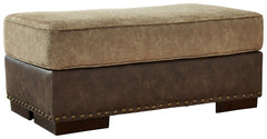 Punctuated by a subtle band of nailhead trim, the cool, contemporary style of this ottoman is perfect for those who love the look of leather. Two textural tones provide twice the style and comfortâ€”and incorporate an added layer of visual interest.<br><b