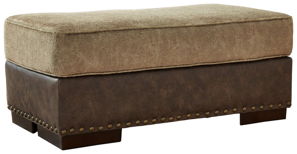 Punctuated by a subtle band of nailhead trim, the cool, contemporary style of this ottoman is perfect for those who love the look of leather. Two textural tones provide twice the style and comfortâ€”and incorporate an added layer of visual interest.<br><b