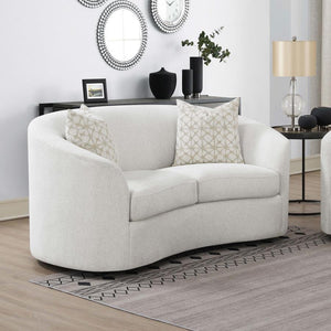  featuring a neutral latte boucle upholstery that presents an inviting and cozy retreat. Gracefully curved and sloped armrests