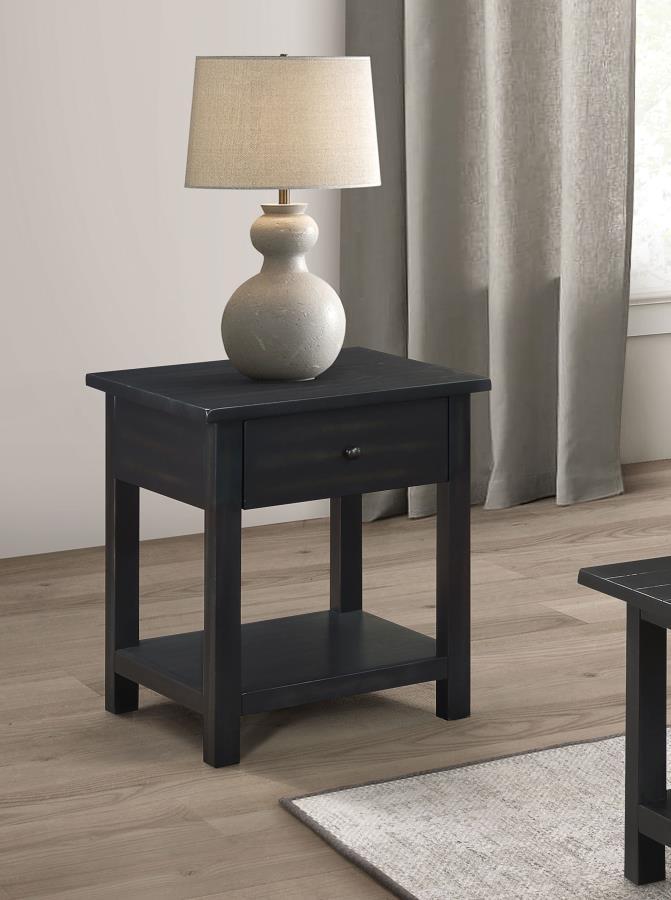 This rustic end table merges classic style with practical storage, making it a charming focal point in any living room. Built from pine wood and reinforced with engineered wood, its square silhouette highlights a subtle, timeworn aesthetic. An integrated 