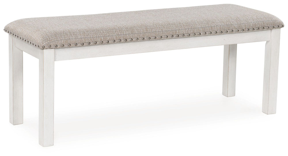 The Robbinsdale dining bench is sure to impress come mealtime. With its antiqued white finish and light gray upholstery with nailhead trim, modern farmhouse-style dining has never been so fashionable. All that-'s missing is you and your family.<br/><br/><