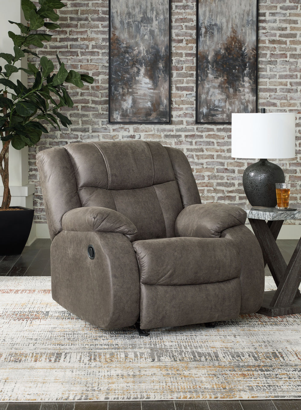 This recliner tees you up to catch up on streaming or enjoy the latest game without breaking the bank. Its easy reclining motion and inviting stitched details craft a stylish seat that keeps you utterly at ease. And with a versatile neutral faux leather, 