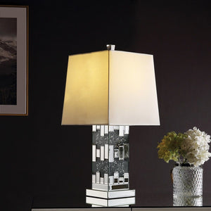 Wonderful mixture between stylish design and modern technology, this Noralie Table Lamp will bring a touch of Hollywood glamourous to any room space. Featuring cuboid shape with mirrored finish and trimmed with clear glass of faux diamond inlayed, this pi