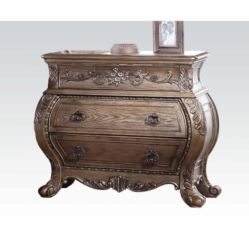 The Ragenardus nightstand is an impeccable example of truly memorable luxurious traditional design. This three-drawer vintage oak nightstand features a detailed French style front and English back in a stunning Bombay shape case, Felt-Lined top drawer, si