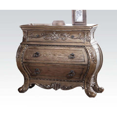 The Ragenardus nightstand is an impeccable example of truly memorable luxurious traditional design. This three-drawer vintage oak nightstand features a detailed French style front and English back in a stunning Bombay shape case, Felt-Lined top drawer, si