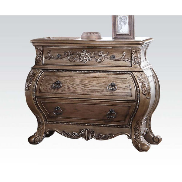 The Ragenardus nightstand is an impeccable example of truly memorable luxurious traditional design. This three-drawer vintage oak nightstand features a detailed French style front and English back in a stunning Bombay shape case, Felt-Lined top drawer, si