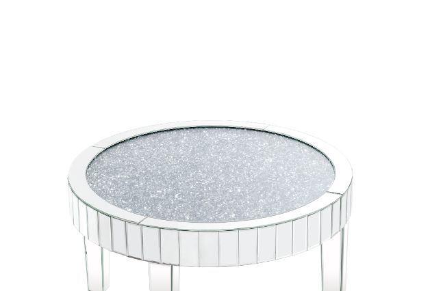This piece strikes a sleek, clean-lined silhouette accented by faux diamonds and mirrored finish. Adding depth and dimension to your room while upping the wow factor in your home. This Ornat Coffee Table is ideal for displaying your precious family photos