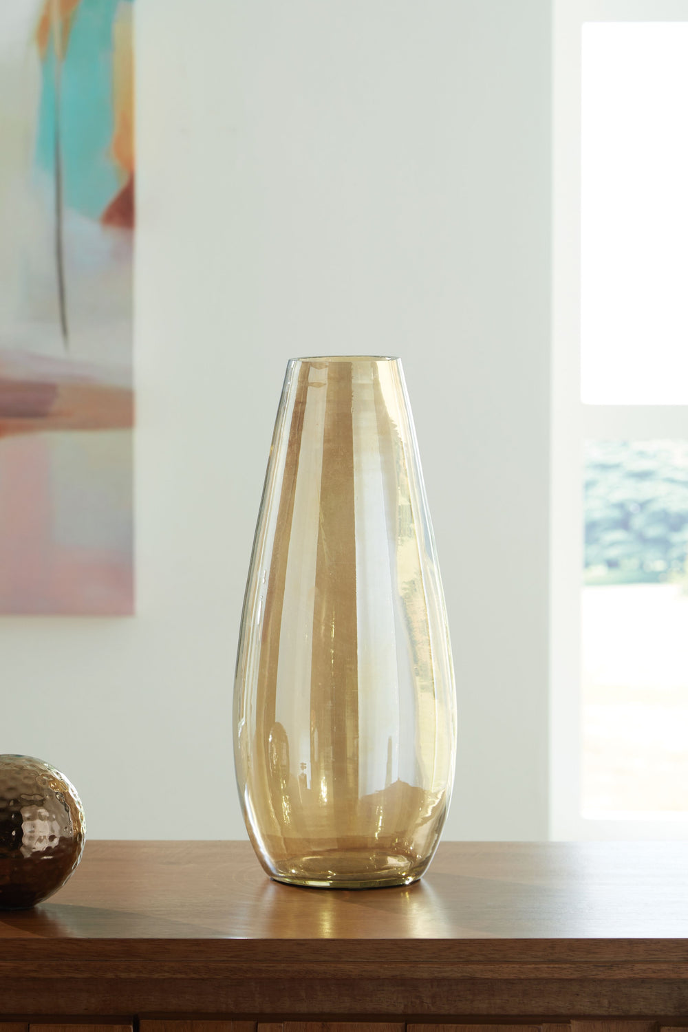 If you love contemporary style, youâ€™re sure to find this vase stunningly on point. Its shimmering amber finish and sleek shape are a feast for the eyes. This show-stopping vessel is gorgeous unadorned or filled with your favorite blooms whether they-'re
