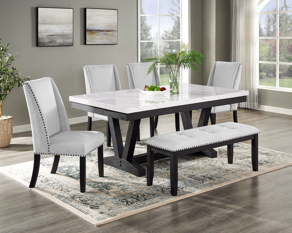 A fresh take on a traditional silhouette makes this group a great addition to your dining space. A faux marble top provides an elegant look while being easy to care for. The trestle base is updated in a contemporary charcoal finish. The upholstered dining