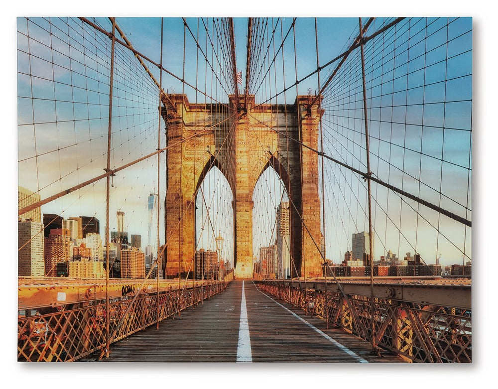 Bring a touch of iconic architecture to your home with this wall art. Captured in beautiful detail, the print on glass showcases the Brooklyn Bridge-'s majestic arches and intricate cables, set against the backdrop of a vibrant city skyline. This captivat