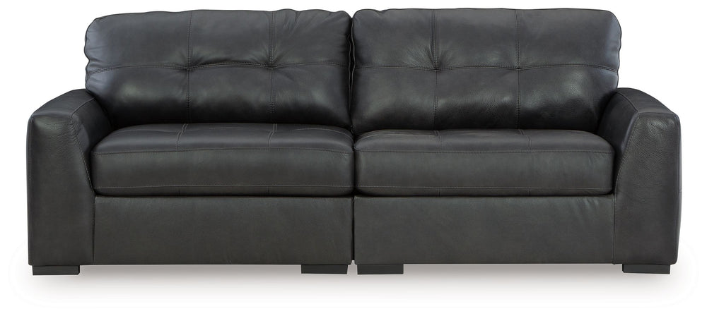 Discover lasting luxury with this sectional loveseat. You-'ll experience the perfect blend of comfort and stylish design with its combination of leather and faux leather. Featuring tufted detailing and low-profile legs, this must-have loveseat ensures bot