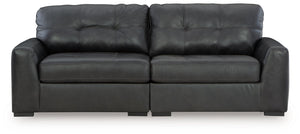 Discover lasting luxury with this sectional loveseat. You-'ll experience the perfect blend of comfort and stylish design with its combination of leather and faux leather. Featuring tufted detailing and low-profile legs, this must-have loveseat ensures bot