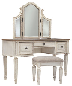 Elevating the art of traditional cottage styling, this 3-piece vanity set is your dream bedroom retreat realized. Its antiqued two-tone aesthetic blends a chipped white with a distressed wood finished top for added charm. Framed drawer fronts and a plushl