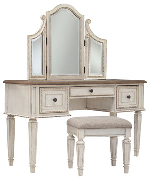 Elevating the art of traditional cottage styling, this 3-piece vanity set is your dream bedroom retreat realized. Its antiqued two-tone aesthetic blends a chipped white with a distressed wood finished top for added charm. Framed drawer fronts and a plushl