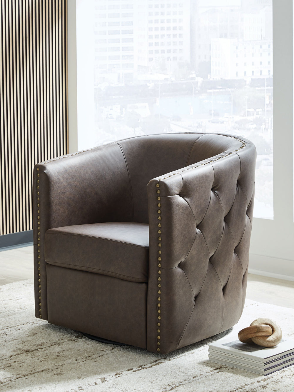 Complete your cozy reading nook or chic seating area with this swivel accent chair. Handsome with its dark faux leather upholstery, the seating is perched on a 360-degree swivel base for the perfect blend of style and function. Design details like tufted 