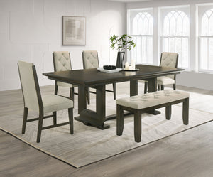 Bring a perfect blend of style and comfort to your dining space with this beautifully designed set. Featuring a sleek, dark-finished table with a sturdy trestle base, it provides a durable and inviting surface for everyday meals and gatherings. The uphols