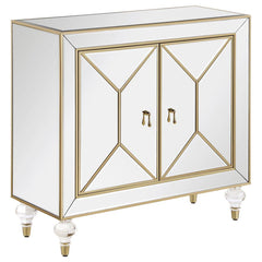 This glamorous accent cabinet lends an air of sophistication and elegance with its polished mirror surfaces and champagne accents. With an inverted beveled design along each of the dual cabinet doors, outlined by a champagne trim, this contemporary accent