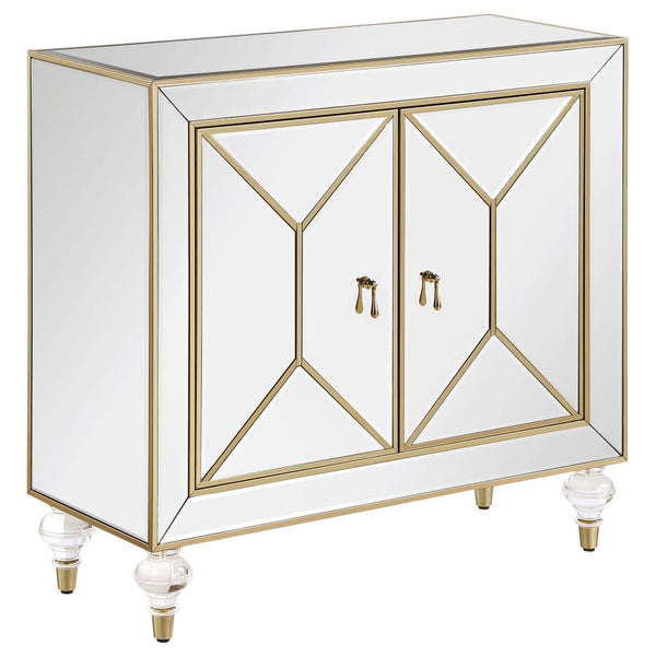 This glamorous accent cabinet lends an air of sophistication and elegance with its polished mirror surfaces and champagne accents. With an inverted beveled design along each of the dual cabinet doors, outlined by a champagne trim, this contemporary accent