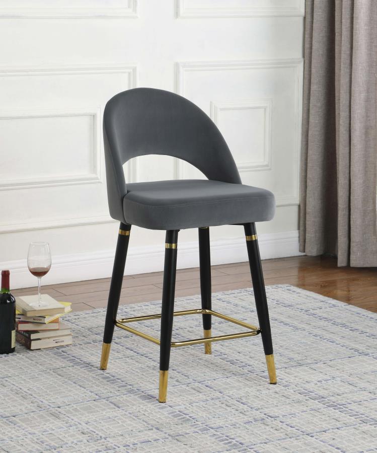 This set of two counter height stools features an elegant bucket style seat that lends a retro-inspired Mid Century modern look. Each stool offers long-lasting, supportive seats for each guest, wrapped in faux leather upholstery that complements numerous 