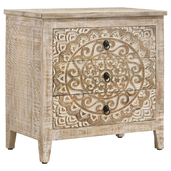 An ornate medallion brings boho charm and artisan character to a farmhouse accent cabinet. Easily doubling as a side table, the cabinet features three drawers perfect for tucking away essentials and accessories in a tidy living area or bedroom. A whitewas