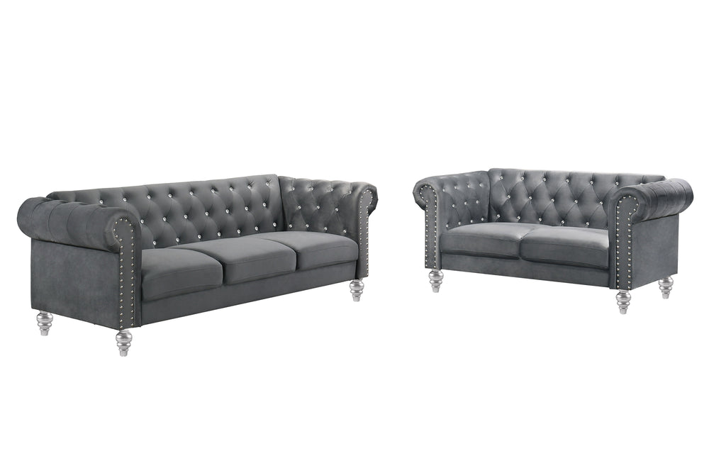 The New Classic Emma Chesterfield Velvet 2-Piece Sofa and Loveseat Set offers a soft and elegant seating solution for your living space. The 100% polyester velvet fabric provides cozy and indulgent seating, while the tufted backs and arms, adorned with gl