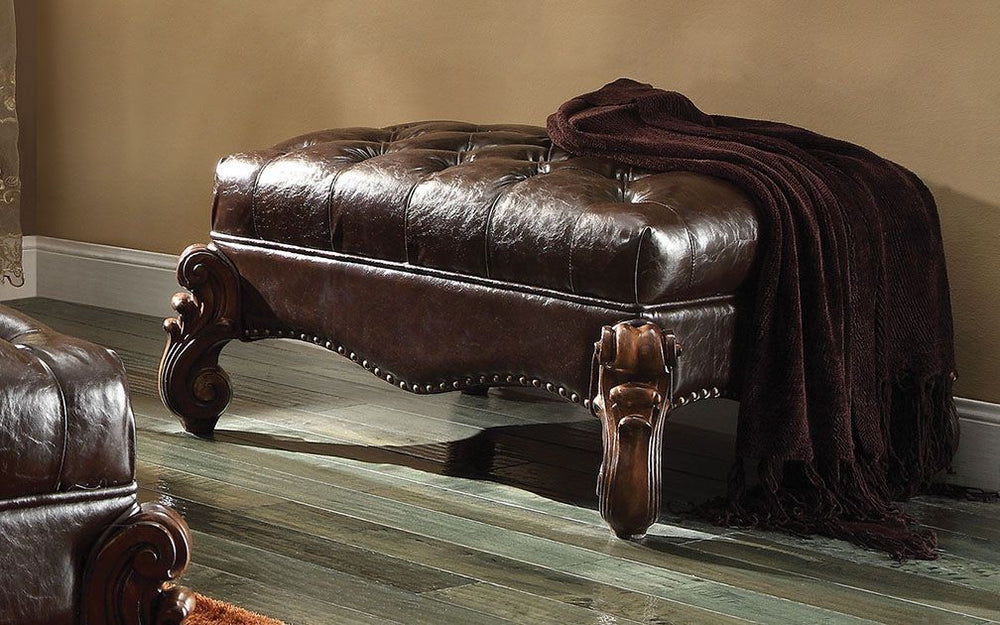 The Versailles Ottoman presents a hand-crafted piece inspired by the most luxurious designs of the past. The stunning PU upholstered ottoman comes in a cherry finish and features a two tone, dark brown, button-tufted seat. Nailhead trim accent and elabora