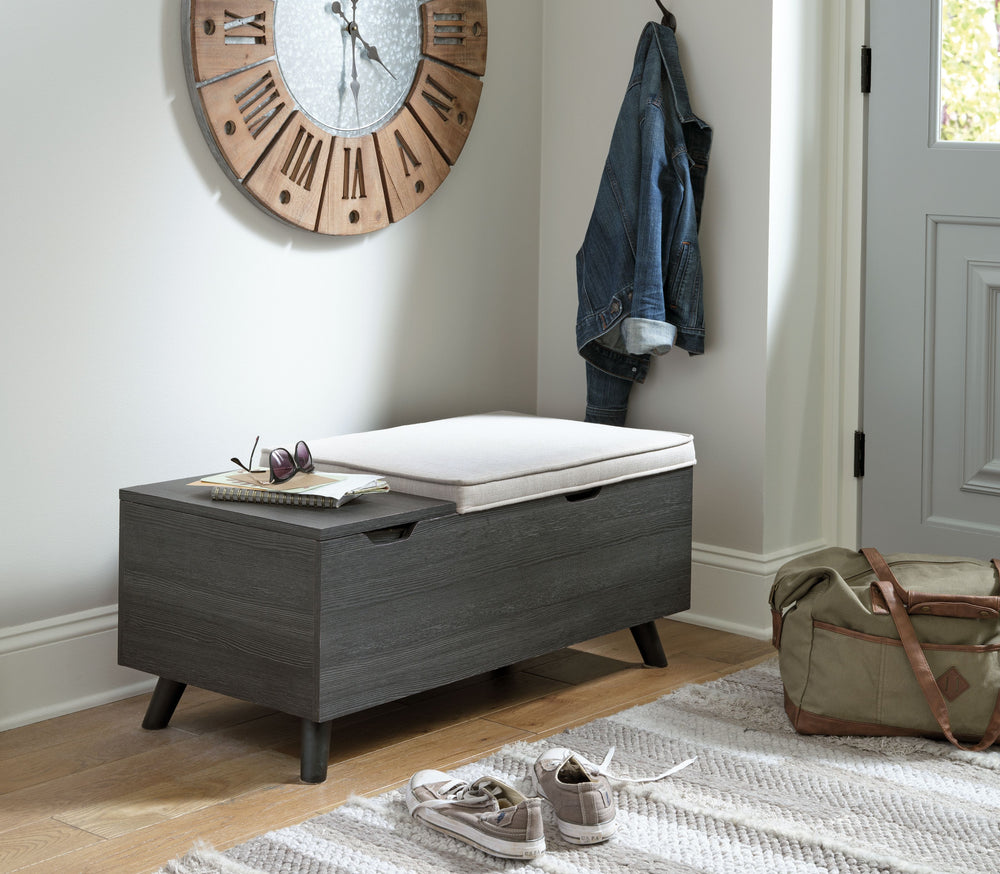 The clean profile of this small storage bench makes an entrance anywhere and everywhere you place it. Replicated blackened wood finish with a grayed textural grain and tapered wood legs lend a fresh flair. Adding form and function, both tops are removable