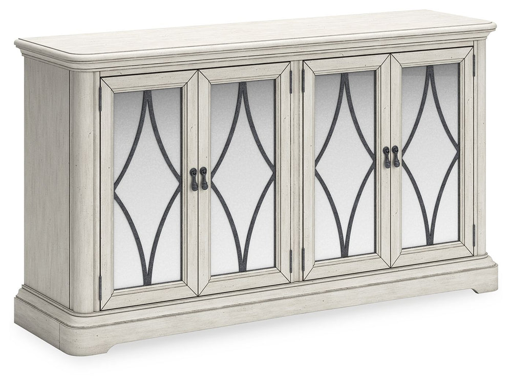 Add a touch of romance to your home with this dining server. The painted finish and shapely silhouette are all about easy elegance. This wide server turns the spotlight on antiqued mirrored doors with overlay fretwork, concealing plenty of storage while a