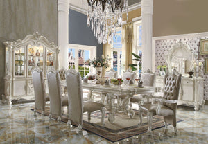 Irresistibly inviting, the Versailles collection displays the unrivaled beauty of the traditional dining. The dining table reflects highly decorative base with oversized scrolled feet, and the upholstered and tapestried chairs with deep button tufted and 
