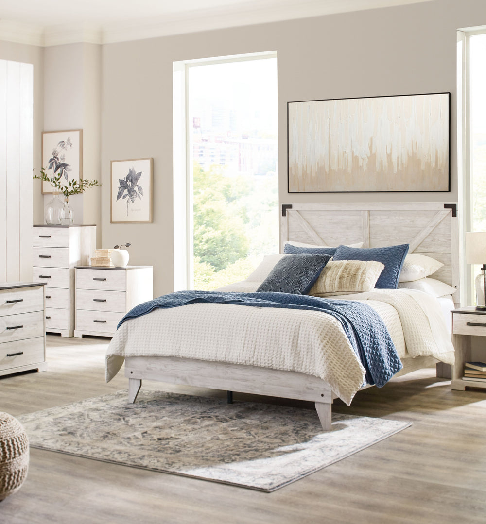 Give provincial a new meaning with the chic look of this full crossbuck panel platform bed. The worn whitewash distressed finish keeps this piece light and fresh while the warm pewter-tone hardware adds an industrial touch. The panel headboard with crossb