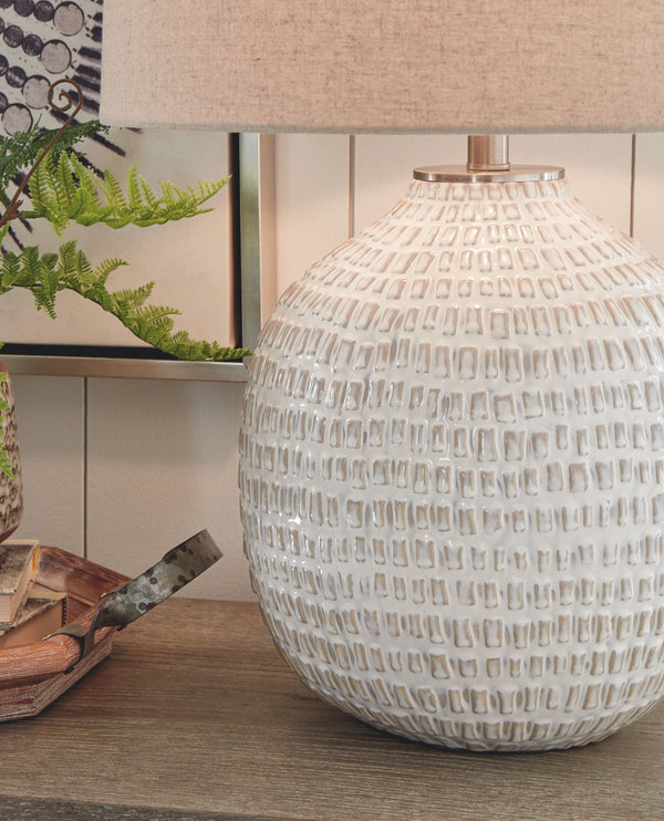  this lamp is capped off with a simple natural lampshade for complete elegance.