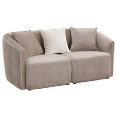 Augment living room seating with the inviting profile of a modern loveseat. Its curved shelter back and sloping arms establish a refined look and feel, while tailored upholstery offers curated appeal. The loveseat is upholstered in chenille with a neutral