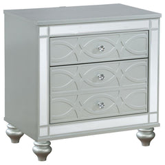 Bring modern glam to a classic design with this transitional two-drawer nightstand. It features a glitzy design that draws the eye in any modern home. It-'s crafted with a vibrant silver metallic finish with fret work detail on the front panels and drawer