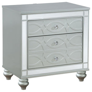 Bring modern glam to a classic design with this transitional two-drawer nightstand. It features a glitzy design that draws the eye in any modern home. It-'s crafted with a vibrant silver metallic finish with fret work detail on the front panels and drawer