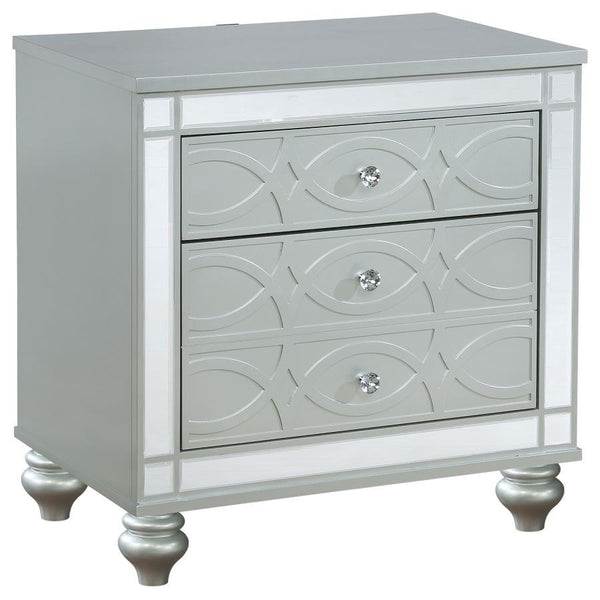 Bring modern glam to a classic design with this transitional two-drawer nightstand. It features a glitzy design that draws the eye in any modern home. It-'s crafted with a vibrant silver metallic finish with fret work detail on the front panels and drawer