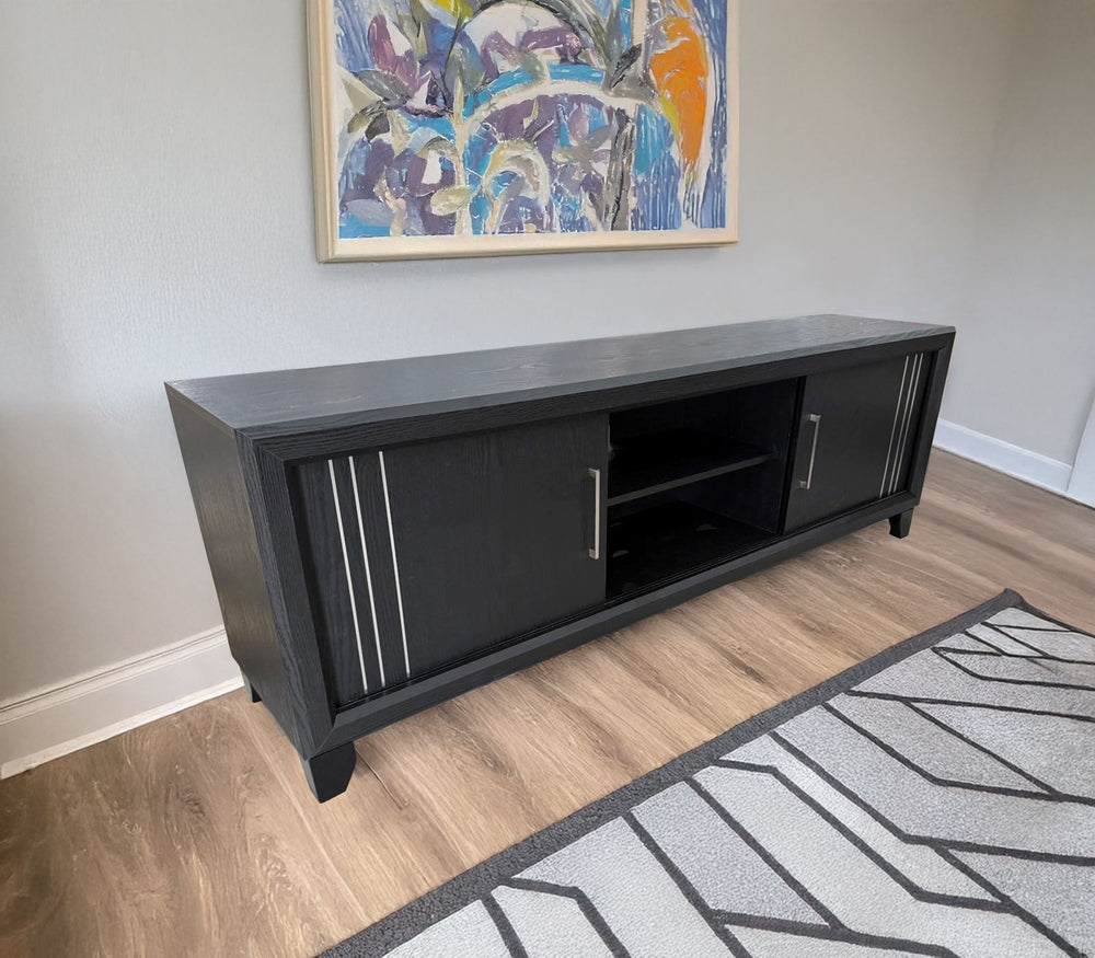Charlie - TV Stand - Charcoal<br/><br/><b>Product Features</b><ul><li>Decorative metal accents</li><li>Dual sliding doors</li><li>Interior shelving</li></ul><br/>