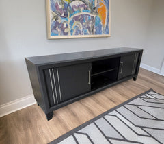 Charlie - TV Stand - Charcoal<br/><br/><b>Product Features</b><ul><li>Decorative metal accents</li><li>Dual sliding doors</li><li>Interior shelving</li></ul><br/>