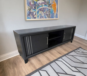 Charlie - TV Stand - Charcoal<br/><br/><b>Product Features</b><ul><li>Decorative metal accents</li><li>Dual sliding doors</li><li>Interior shelving</li></ul><br/>