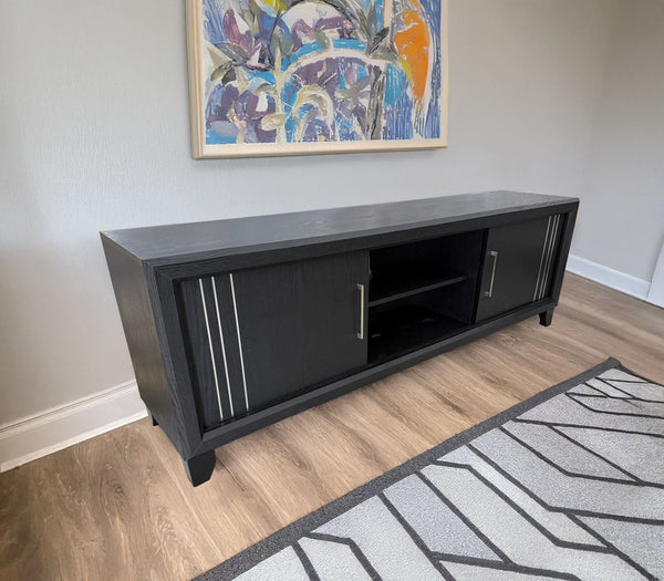 Charlie - TV Stand - Charcoal<br/><br/><b>Product Features</b><ul><li>Decorative metal accents</li><li>Dual sliding doors</li><li>Interior shelving</li></ul><br/>