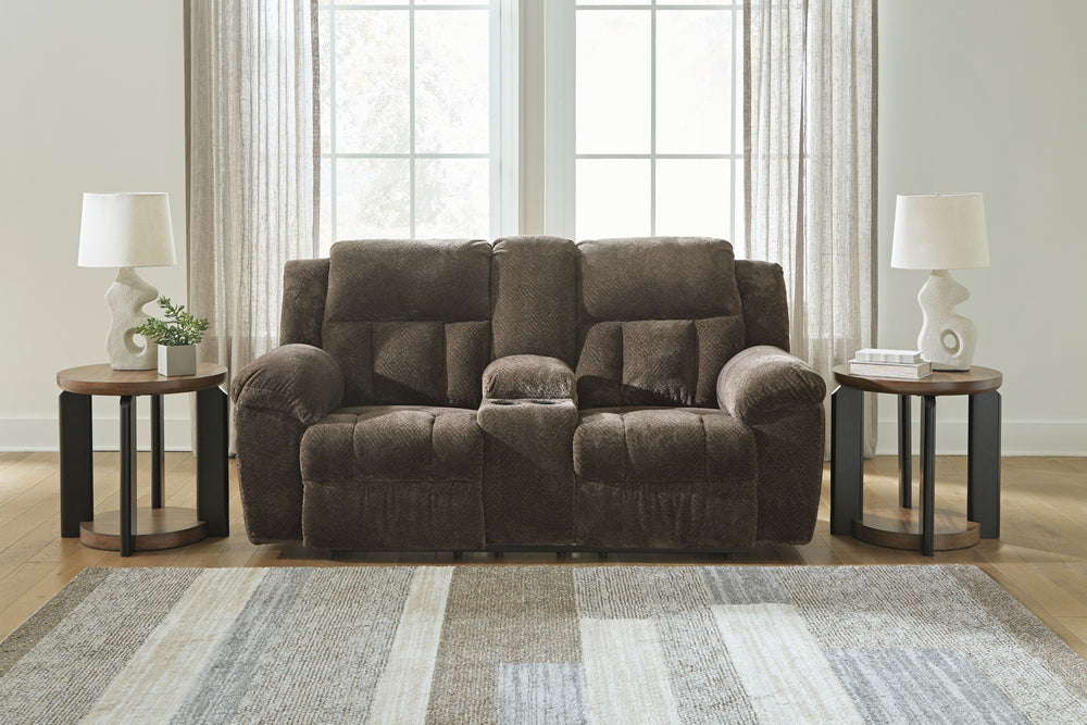 With its large-scale design, this extra-spacious reclining loveseat with console is a masterclass in accessible style. Plush, ultra-soft upholstery keeps everyone cozy as you lounge with family or guests. In a neutral hue, it seamlessly suits different ae