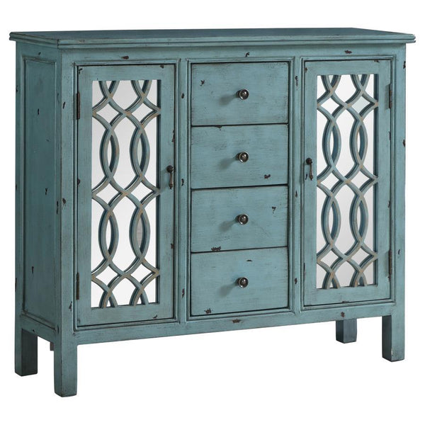 This well-crafted wooden cabinet adds a splash of color and classic charm to any space. Finished in a distressed blue, it features four center drawers for organizing linens or silverware, while two side doors with mirrored insets and carved lattice detail
