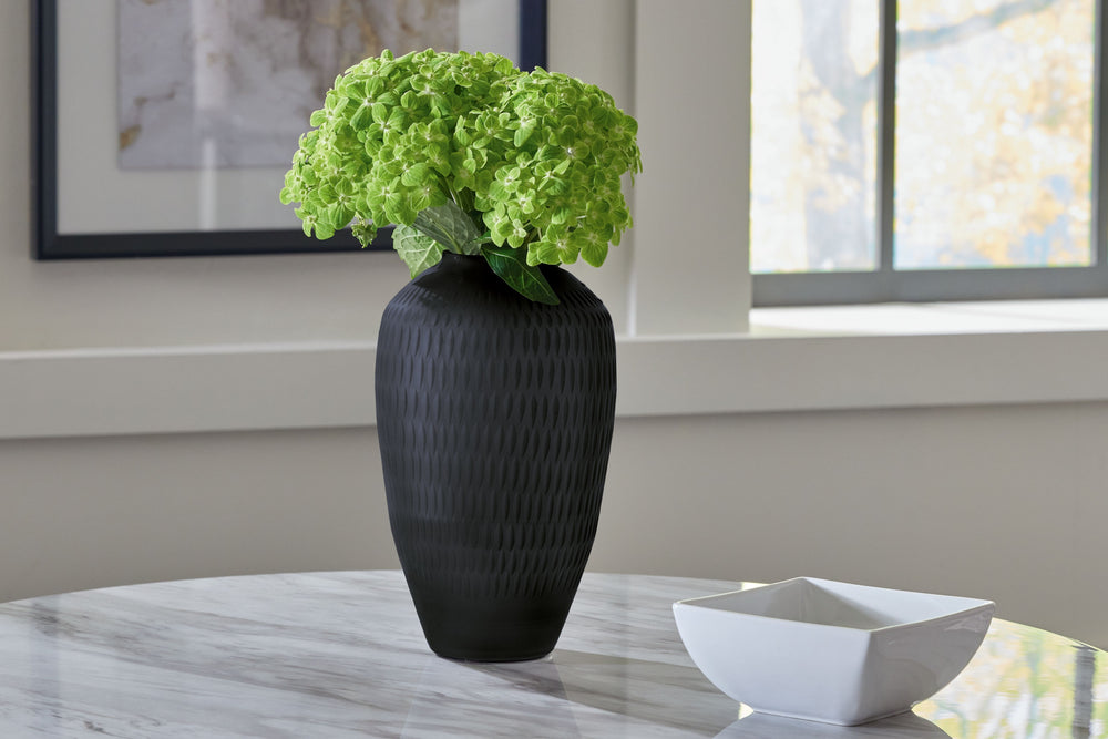 Let your eyes trace the alluring pattern running along this cut-glass vase. Its cylindrical silhouette is topped in contemporary splendor with a slate finish. Youâ€™ll surely enjoy the understated style and ever-present interest it brings to your decor.<b