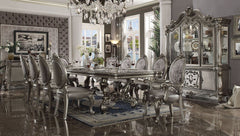 Irresistibly inviting, the Versailles collection displays the unrivaled beauty of the traditional dining. The dining table reflects highly decorative base with oversized scrolled feet, and the upholstered and tapestried chairs with Nailhead trim accents a