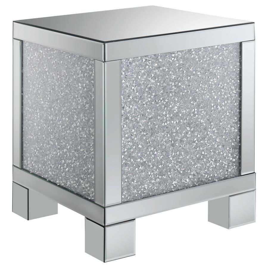 This 20-inch square mirrored end table brings a touch of glam to any space. Its engineered wood frame is adorned with shimmering acrylic crystal accents, adding sparkle and elegance. Fully mirrored surfaces enhance light and dimension, while the clean, sq