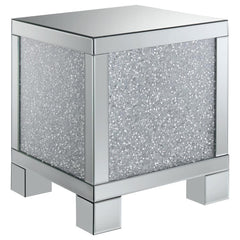 This 20-inch square mirrored end table brings a touch of glam to any space. Its engineered wood frame is adorned with shimmering acrylic crystal accents, adding sparkle and elegance. Fully mirrored surfaces enhance light and dimension, while the clean, sq