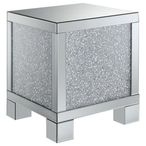 This 20-inch square mirrored end table brings a touch of glam to any space. Its engineered wood frame is adorned with shimmering acrylic crystal accents, adding sparkle and elegance. Fully mirrored surfaces enhance light and dimension, while the clean, sq