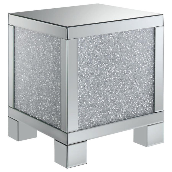 This 20-inch square mirrored end table brings a touch of glam to any space. Its engineered wood frame is adorned with shimmering acrylic crystal accents, adding sparkle and elegance. Fully mirrored surfaces enhance light and dimension, while the clean, sq