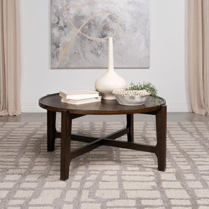  the coffee table is a cocktail centerpiece that grounds the room in solid wood durability. Its dark brown finish glows under the touch of light