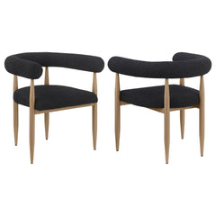 Update your dining table with the fresh ambiance and vintage inspired character of a set of two modern armchairs. Each features a compelling silhouette with a U-shaped backrest and arms. Black boucle upholstery adds the perfect dose of texture and depth, 