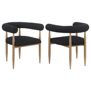Update your dining table with the fresh ambiance and vintage inspired character of a set of two modern armchairs. Each features a compelling silhouette with a U-shaped backrest and arms. Black boucle upholstery adds the perfect dose of texture and depth, 